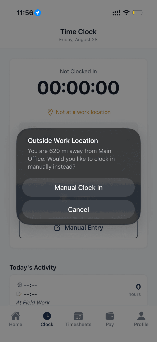 Mobile dialog showing the employee is 620 miles from the work location, offering a manual clock in